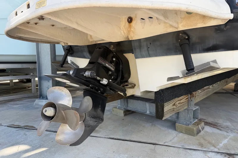 Slide: The Image of 2006 Sea Ray 240 Sundeck boat propeller and stern drive on a dry dock. - 8