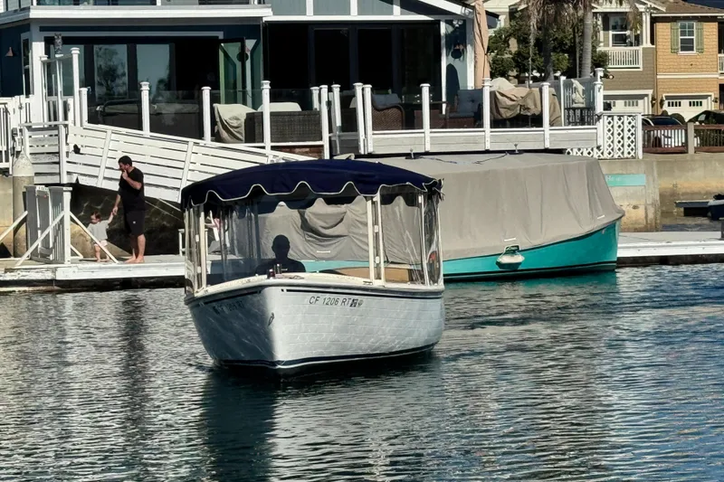 Slide: The Image of 2008 Duffy Snug Harbor boat docked near waterfront homes. - 1