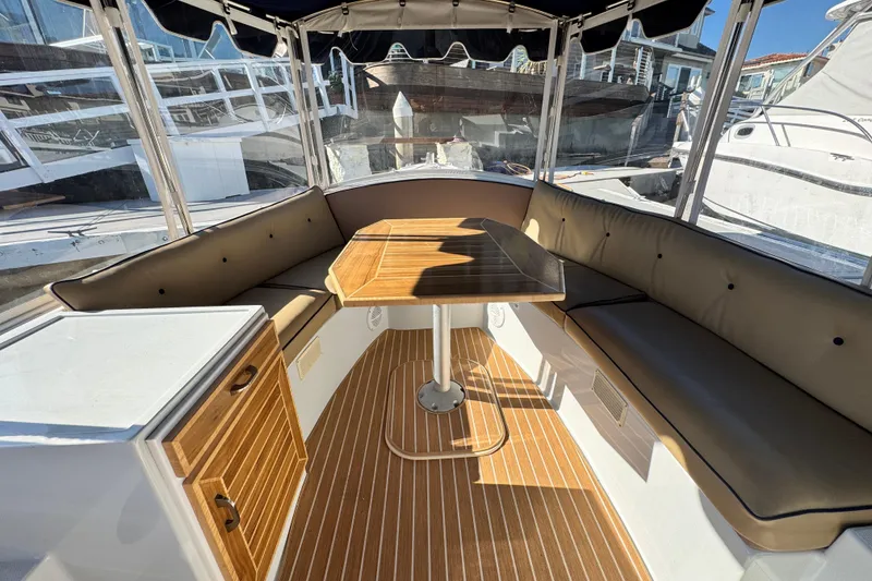 Slide: The Image of Interior of a 2008 Duffy Snug Harbor boat with seating and wooden table. - 5