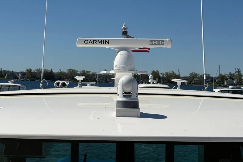 Slide: The Image of 2019 Tiara Yachts C44 Coupe with Garmin xHD2 radar on deck, docked by waterfront homes. - 15