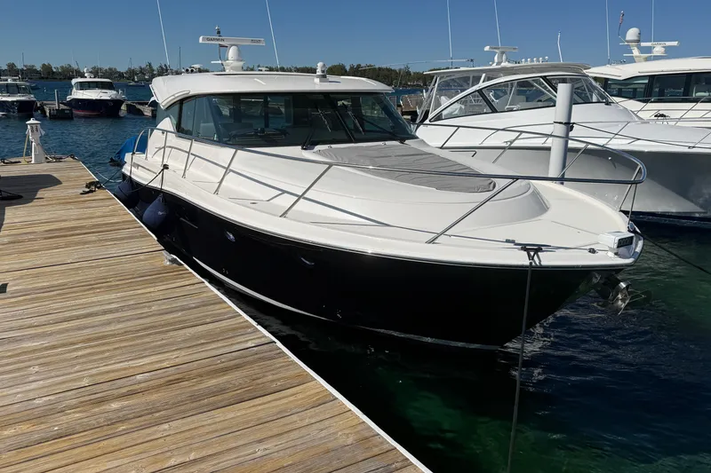 Slide: The Image of 2019 Tiara Yachts C44 Coupe docked at marina, sunny day. - 2
