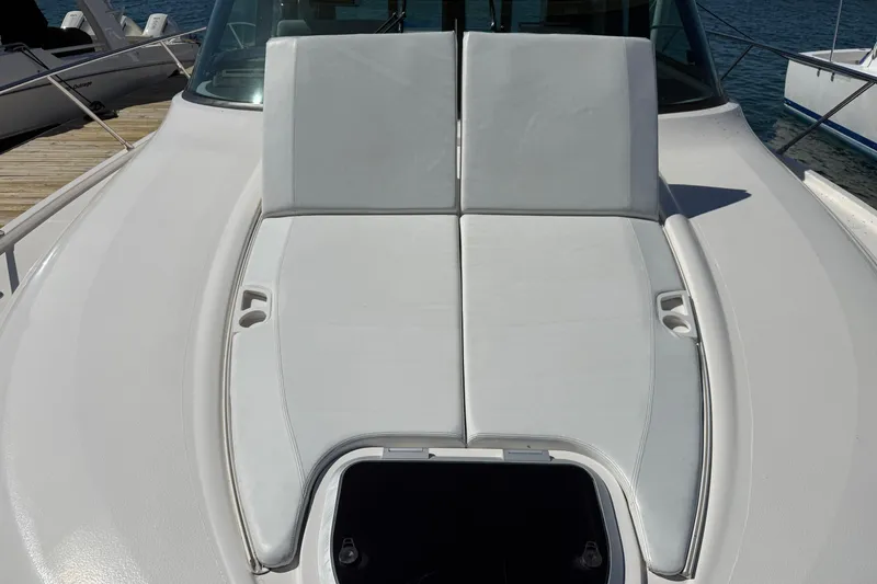 Slide: The Image of 2019 Tiara Yachts C44 Coupe deck with cushioned seating and cup holders. - 20
