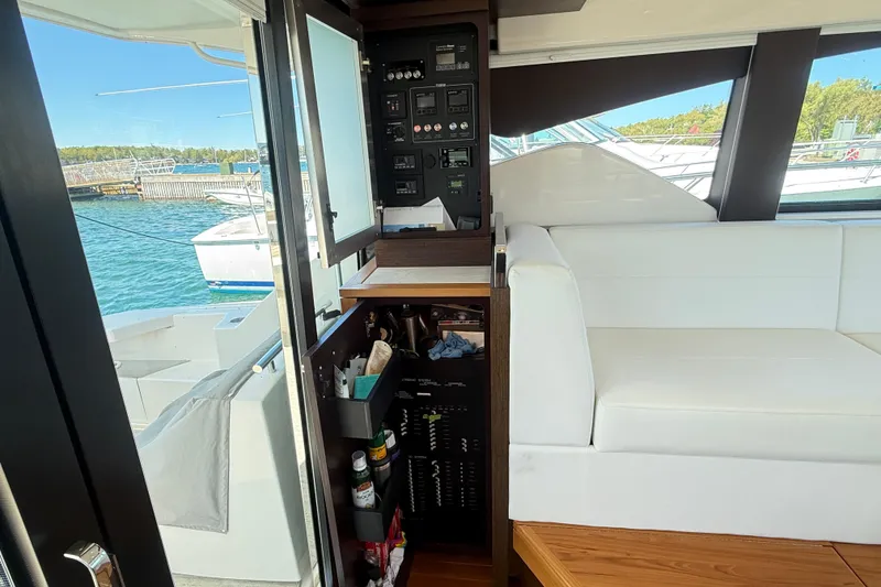 Slide: The Image of Interior of 2019 Tiara Yachts C44 Coupe with control panel and white seating. - 23
