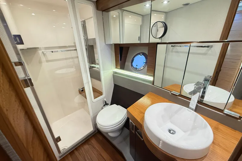 Slide: The Image of Luxurious bathroom in 2019 Tiara Yachts C44 Coupe, featuring modern fixtures and elegant wood accents. - 31