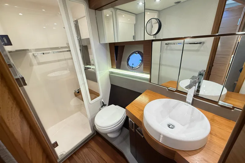Slide: The Image of Luxurious bathroom in 2019 Tiara Yachts C44 Coupe with modern fixtures and wood accents. - 32