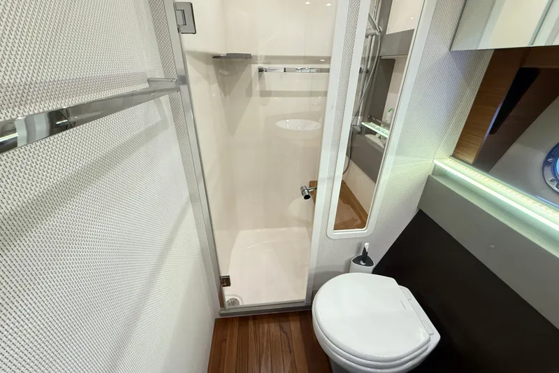 Slide: The Image of Luxurious bathroom in 2019 Tiara Yachts C44 Coupe with modern fixtures and wooden flooring. - 33