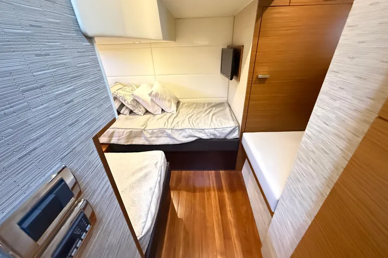 Slide: The Image of Interior cabin of 2019 Tiara Yachts C44 Coupe with twin beds and modern decor. - 35
