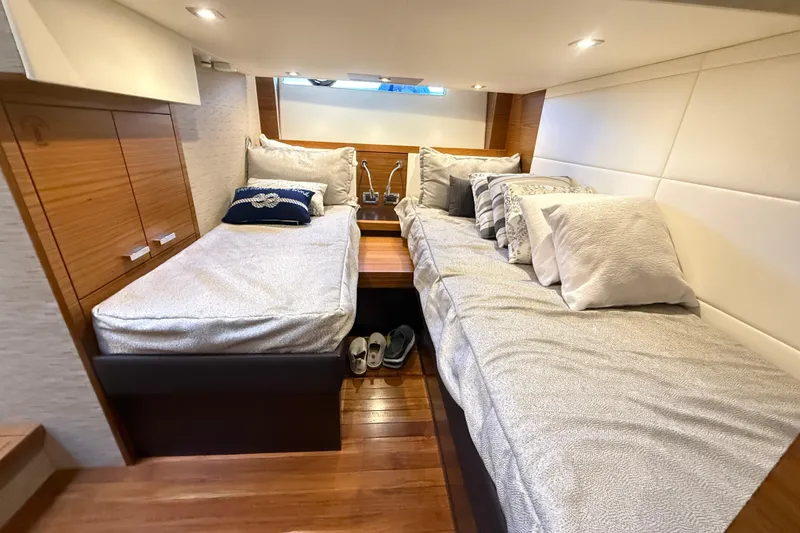 Slide: The Image of Luxurious 2019 Tiara Yachts C44 Coupe cabin with twin beds and elegant wood finish. - 36