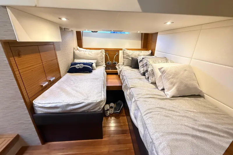 Slide: The Image of Interior cabin of 2019 Tiara Yachts C44 Coupe with twin beds and cozy decor. - 37