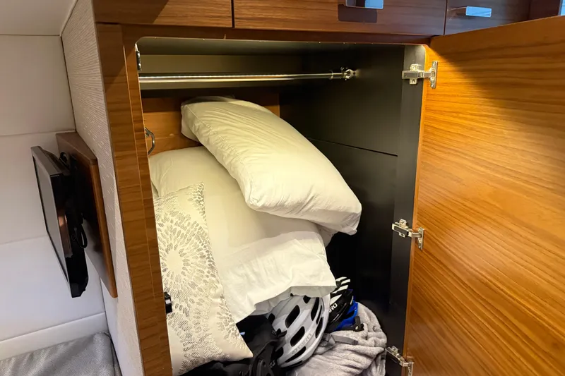 Slide: The Image of Cabinet in 2019 Tiara Yachts C44 Coupe with pillows and a helmet stored inside. - 38