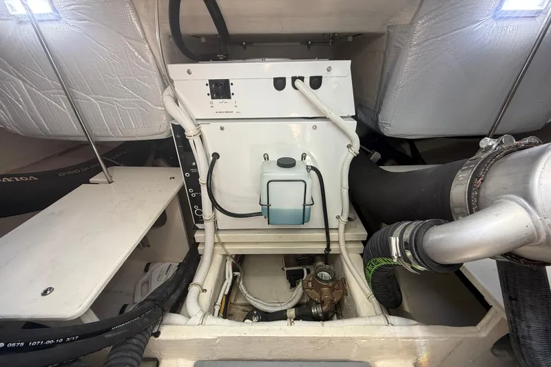 Slide: The Image of Engine compartment of a 2019 Tiara Yachts C44 Coupe, showcasing mechanical components and wiring. - 44