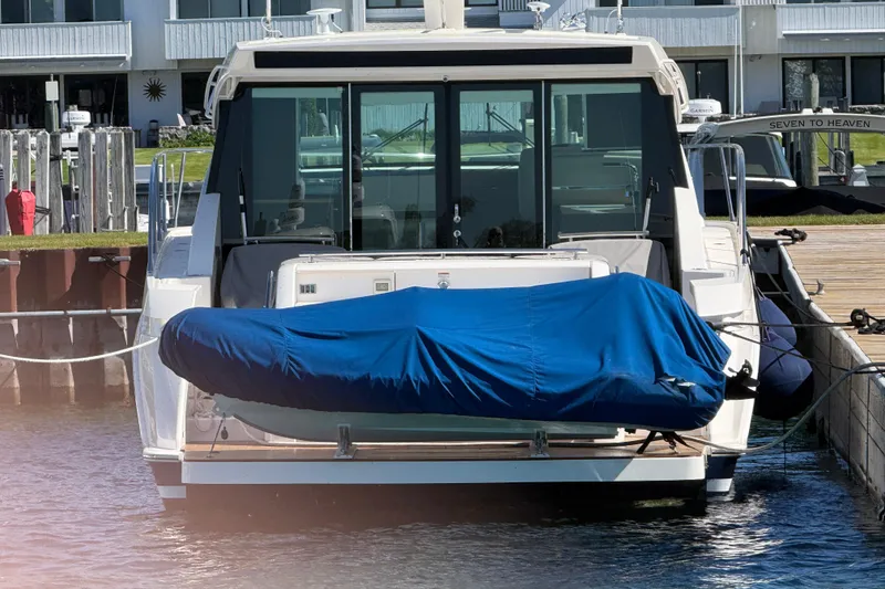 Slide: The Image of 2019 Tiara Yachts C44 Coupe docked with covered equipment on deck. - 5