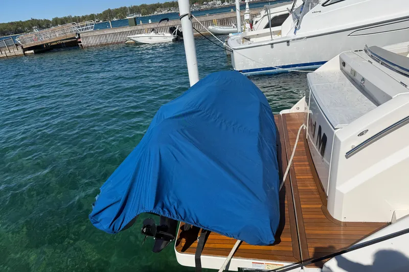 Slide: The Image of 2019 Tiara Yachts C44 Coupe with covered outboard motor at dock. - 6