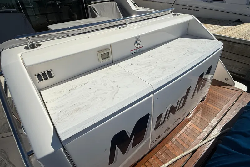 Slide: The Image of 2019 Tiara Yachts C44 Coupe stern view with wooden deck and storage compartments. - 7