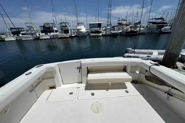Slide: The Image of 2001 Tiara Yachts 2900 Open at marina, showcasing spacious deck and surrounding boats. - 10