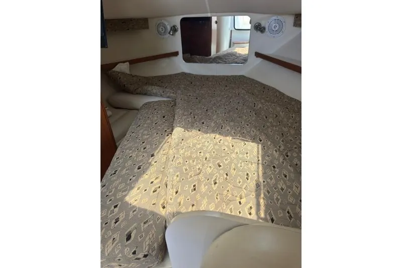 Slide: The Image of 2001 Tiara Yachts 2900 Open cabin interior with patterned bedding and cozy layout. - 18