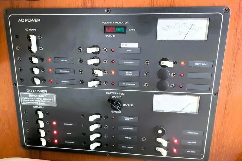 Slide: The Image of Electrical control panel on a 2001 Tiara Yachts 2900 Open, featuring AC and DC power switches. - 20
