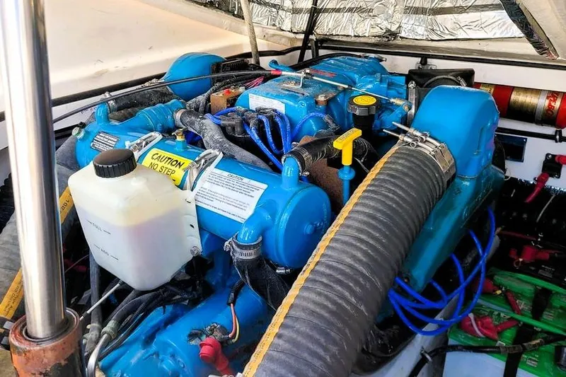 Slide: The Image of Engine compartment of a 2001 Tiara Yachts 2900 Open, featuring blue engine components. - 23