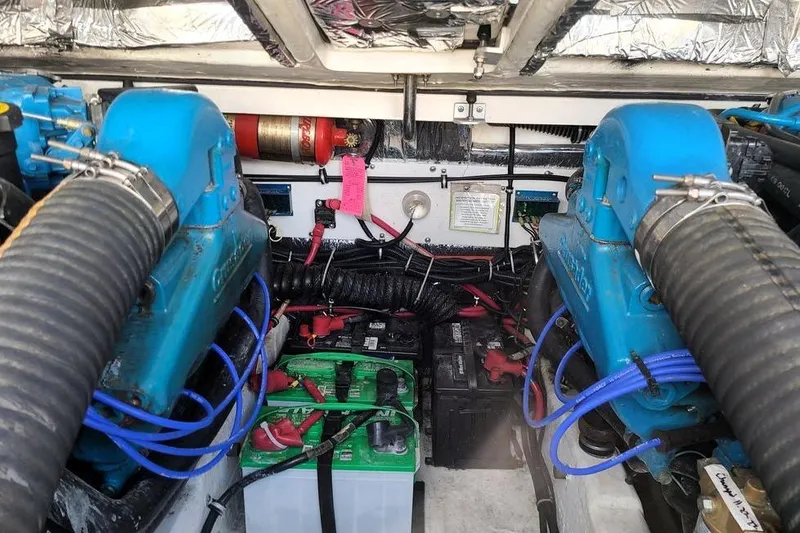Slide: The Image of Engine compartment of a 2001 Tiara Yachts 2900 Open, featuring dual engines and battery setup. - 24