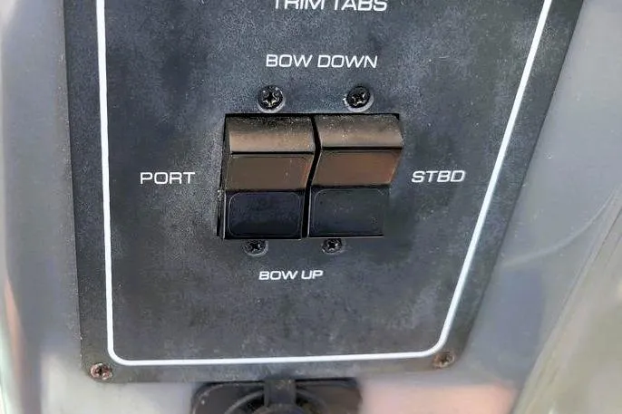 Slide: The Image of Control panel of a 2001 Tiara Yachts 2900 Open, featuring trim tab switches. - 5