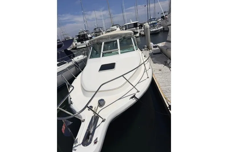 Slide: The Image of 2001 Tiara Yachts 2900 Open docked at a marina, showcasing sleek design and spacious deck. - 8