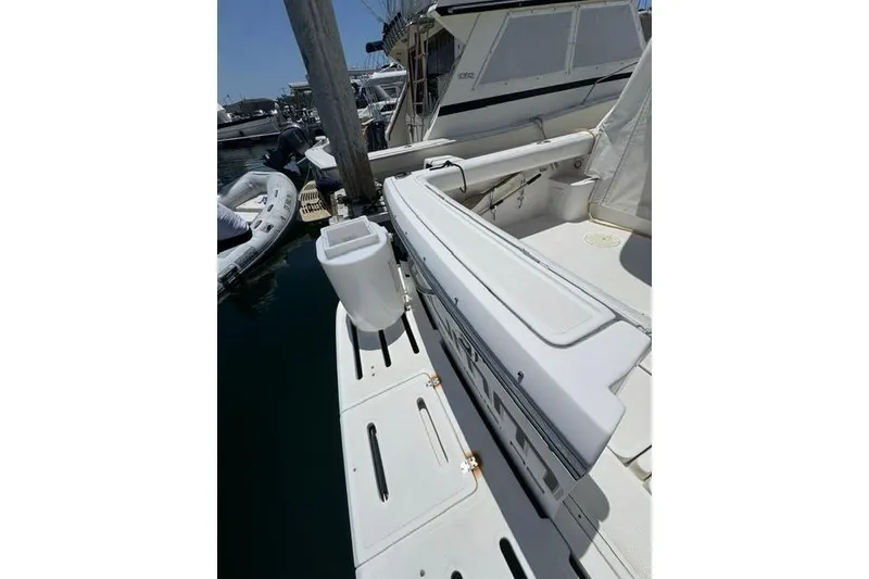 Slide: The Image of 2001 Tiara Yachts 2900 Open docked, showcasing deck and seating area. - 9