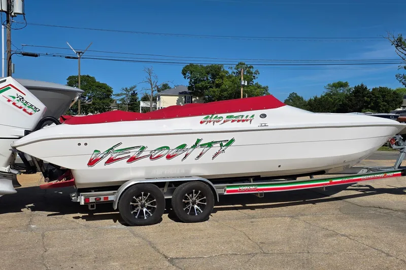 The Image of 2024 Velocity 290 Sport Cruiser on trailer, featuring sleek design and vibrant graphics. - 0
