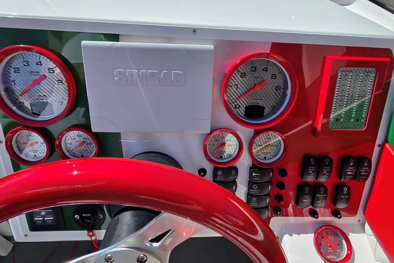 Slide: The Image of Dashboard of 2024 Velocity 290 Sport Cruiser with red accents and Simrad display. - 10