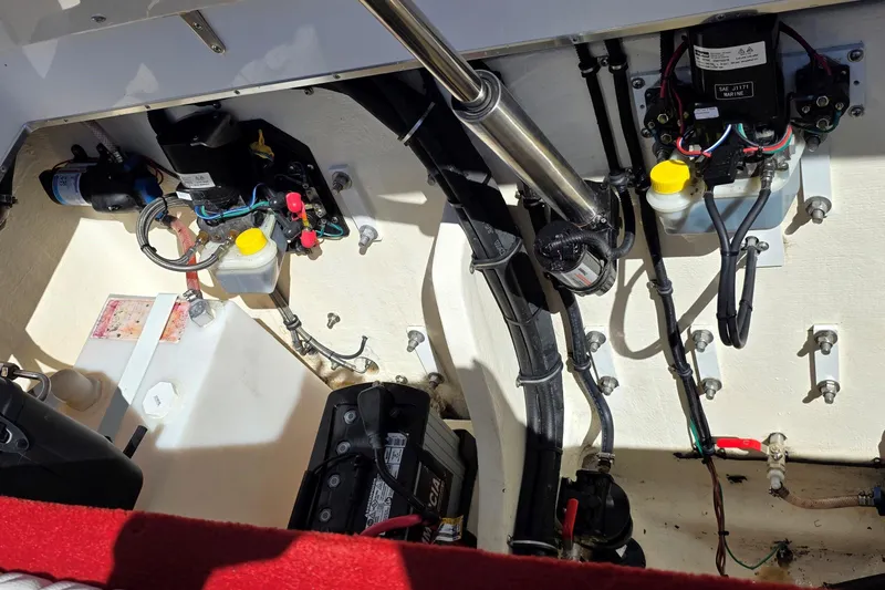 Slide: The Image of Engine compartment of 2024 Velocity 290 Sport Cruiser with visible wiring and components. - 14