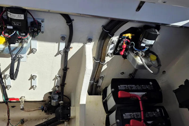 Slide: The Image of Engine compartment of 2024 Velocity 290 Sport Cruiser, showcasing wiring and battery setup. - 15