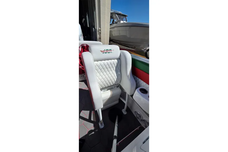 Slide: The Image of 2024 Velocity 290 Sport Cruiser interior with white quilted seating and logo. - 19