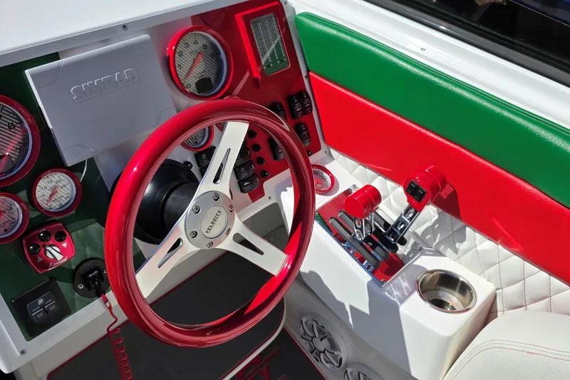 Slide: The Image of 2024 Velocity 290 Sport Cruiser dashboard with red steering wheel and vibrant controls. - 3