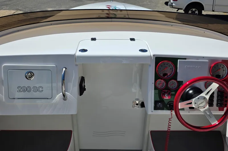 Slide: The Image of 2024 Velocity 290 Sport Cruiser dashboard with red steering wheel and instrument panel. - 4