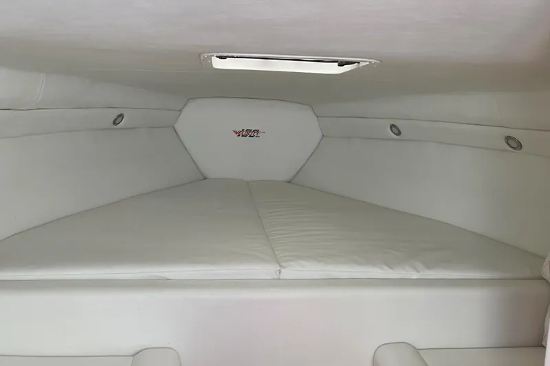 Slide: The Image of 2024 Velocity 290 Sport Cruiser interior cabin with white upholstery and sleek design. - 8
