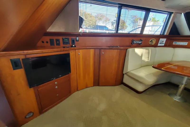 Slide: The Image of Interior of 2000 Silverton 42 Convertible yacht with wood cabinetry and seating area. - 11