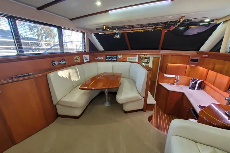 Slide: The Image of Interior of 2000 Silverton 42 Convertible yacht with dining area and kitchenette. - 12
