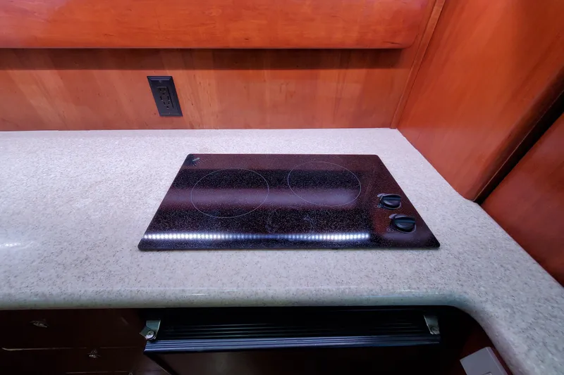 Slide: The Image of Electric stovetop on a Silverton 42 Convertible yacht, 2000 model, with wooden cabinetry. - 18