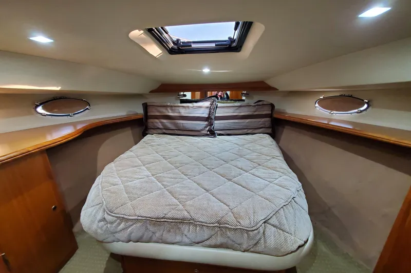 Slide: The Image of Luxurious cabin interior of a 2000 Silverton 42 Convertible yacht with cozy bedding. - 22