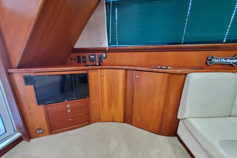 Slide: The Image of Interior of 2000 Silverton 42 Convertible yacht with wood cabinetry and TV. - 23