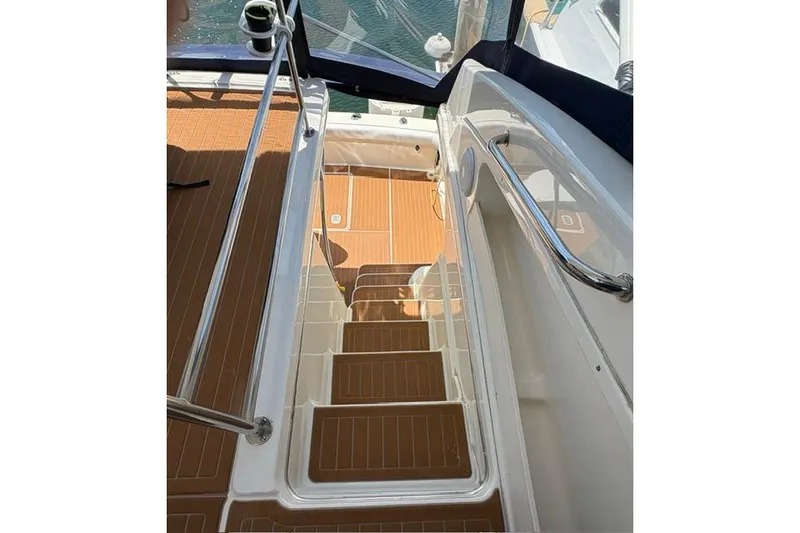 Slide: The Image of Staircase on 2000 Silverton 42 Convertible yacht with teak flooring and stainless steel railings. - 26