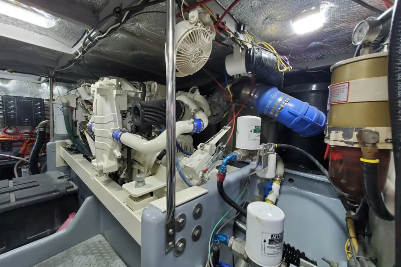 Slide: The Image of Engine room of a 2000 Silverton 42 Convertible yacht, showcasing mechanical components. - 31