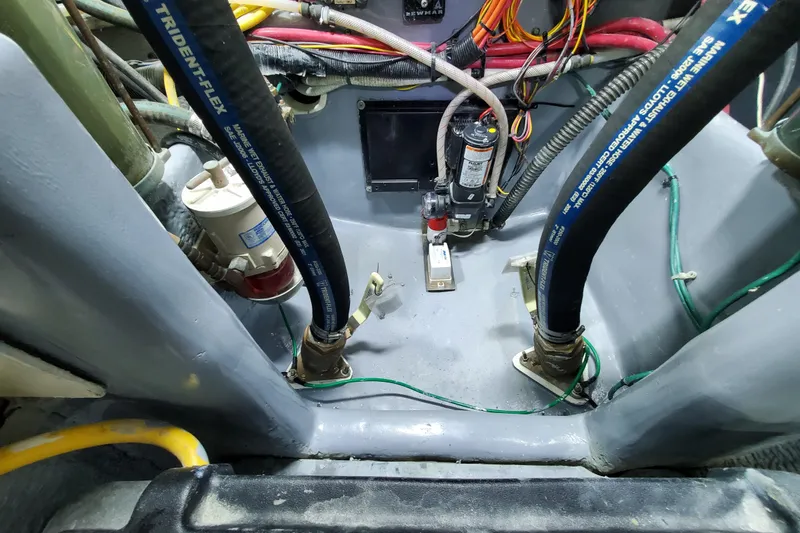Slide: The Image of Engine compartment of a 2000 Silverton 42 Convertible boat with hoses and wiring. - 32