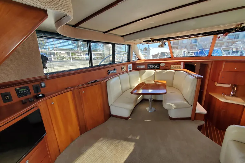 Slide: The Image of Luxurious interior of 2000 Silverton 42 Convertible yacht with plush seating and wooden finishes. - 33