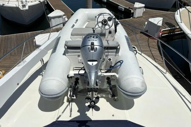 Slide: The Image of Inflatable dinghy with motor on 2000 Silverton 42 Convertible yacht deck. - 34