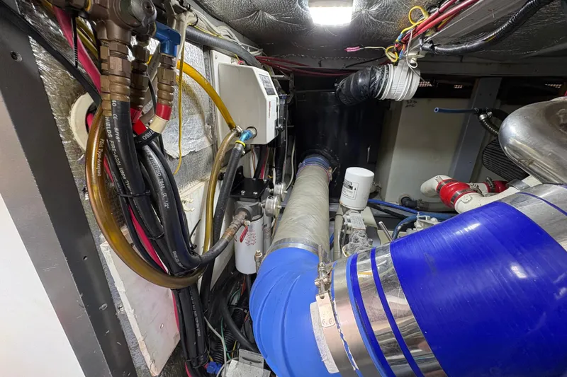 Slide: The Image of Engine room of a 2000 Silverton 42 Convertible with visible hoses and wiring. - 46