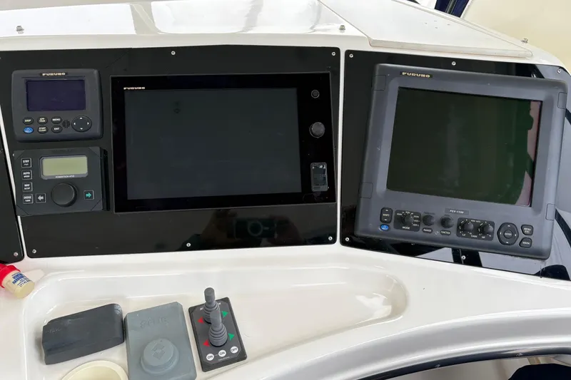 Slide: The Image of Control panel of a 2000 Silverton 42 Convertible boat with navigation equipment. - 47