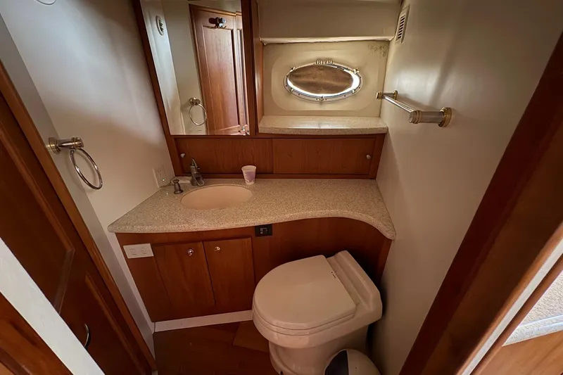 Slide: The Image of Bathroom interior of 2000 Silverton 42 Convertible yacht with sink and toilet. - 48