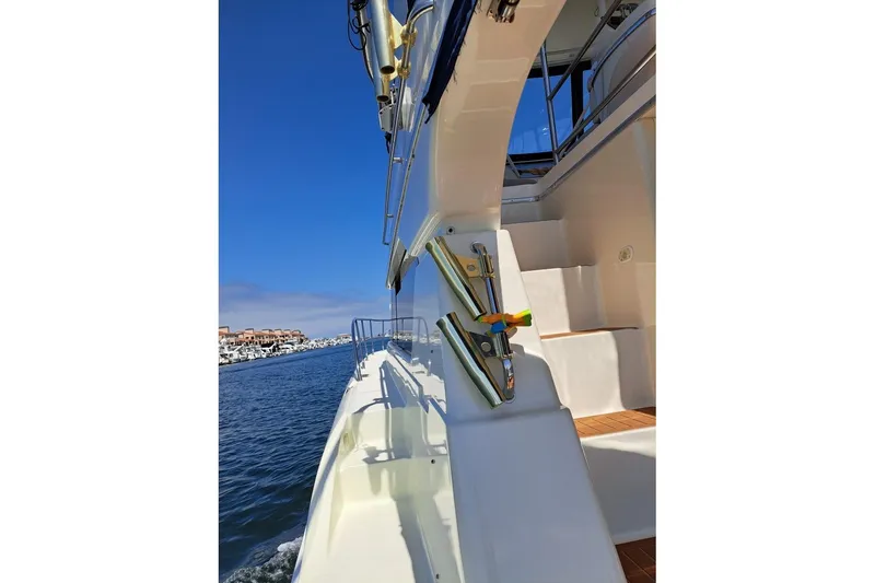 Slide: The Image of 2000 Silverton 42 Convertible yacht cruising on a sunny day, showcasing sleek design. - 52