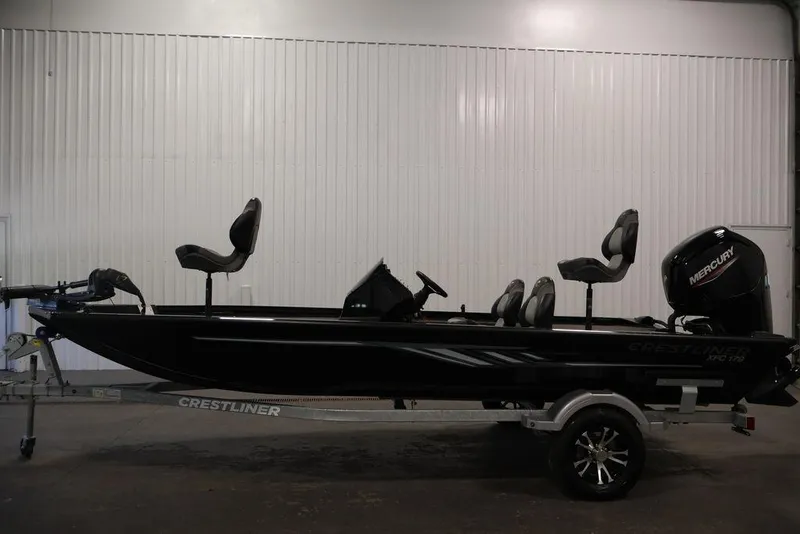 Slide: The Image of 2024 Crestliner XFC 179 fishing boat with Mercury engine, displayed indoors. - 16