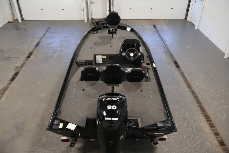 Slide: The Image of 2024 Crestliner XFC 179 fishing boat with Mercury 90 engine in a garage setting. - 17